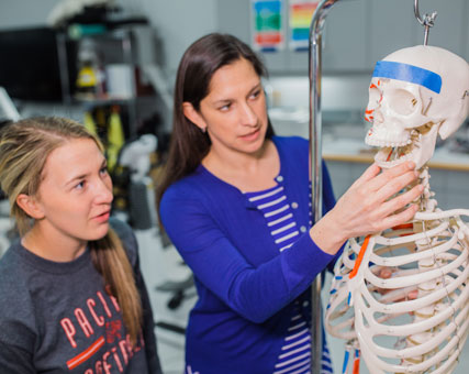 Photo of a teacher and student. Link to Gifts of Real Estate